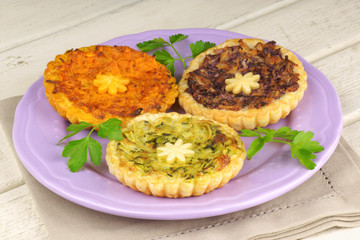 Three mini vegetarian quiches