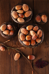 wild hazelnut in iron bowls on wooden table