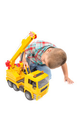 little boy plays with toy truck