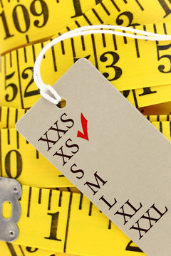 Measuring Tape Closeup With Xs Size Tag