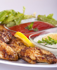 fried chicken wings in sauce with mayonnaise and tomato sauce