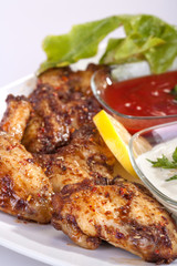fried chicken wings in sauce with mayonnaise and tomato sauce