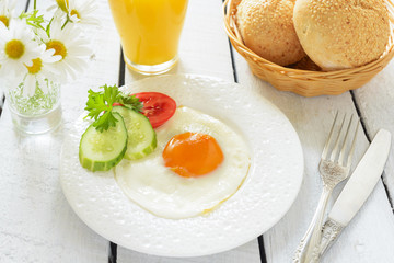 Breakfast with fried egg and orange juice