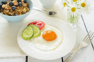 Healthy breakfast with fried egg and muesli
