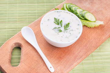 cold cucumber soup with slices of cucumber