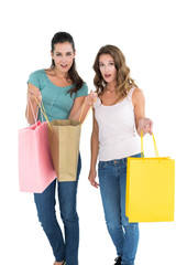 Two happy young female friends with shopping bags