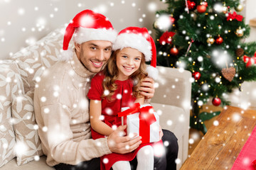 smiling father and daughter holding gift box