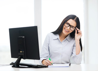 smiling businesswoman or student with eyeglasses