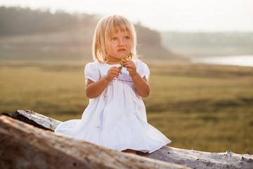 pretty girl in white dress beside the pond
