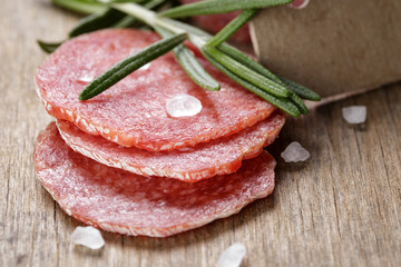 italian salami sausage slices with rosemary and sea salt