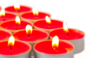 Glowing red tea lights on white