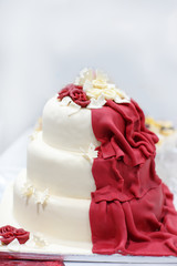 Wedding cake in cream and dark red.