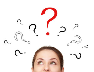 Thinking woman looking up on many question signs above