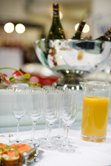 Empty champagne glasses and finger food on festive wedding table