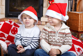 Fototapeta premium Two little sibling boys being happy about christmas present
