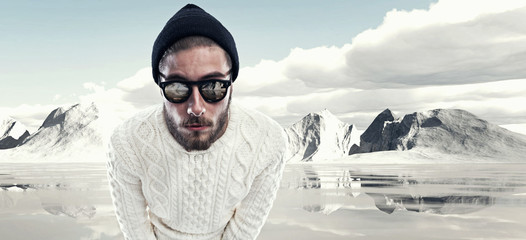 Cool man with beard in winter fashion. Wearing white woolen swea