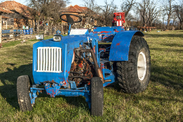 Handmade assembled tractor in a mountain farm