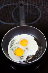 two fried eggs in frying pan