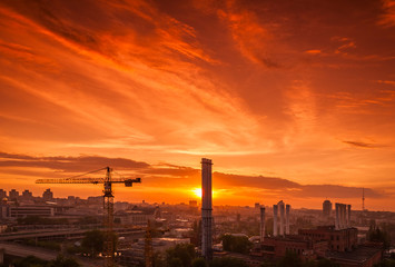 Crane in the construction site under the sunset