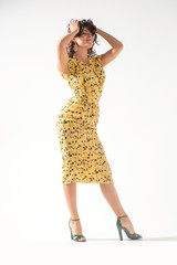Beautiful girl in a yellow dress dancing