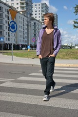 Teenage boy walking on the pedestrian crossing