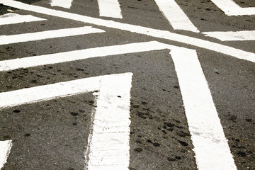 White Painted Pedestrian Crossing On Tarmac Roadway