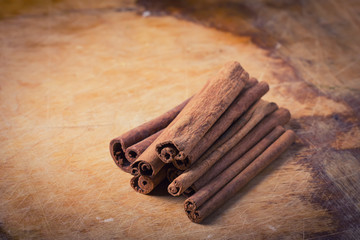 Cinnamon on wooden background.