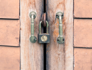 Old key lock on wooden wall