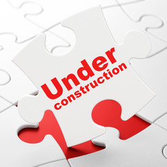 Web development concept: Under Construction on puzzle background