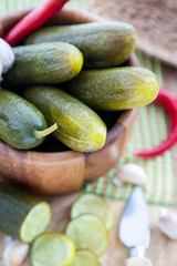 Pickled cucumbers in wooden bowl