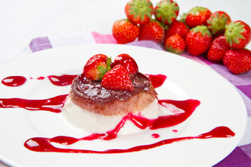 panna cotta dessert with strawberry sirup and fresh strawberry