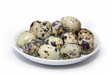 Fototapeta premium quail eggs in a bowl isolated on white background