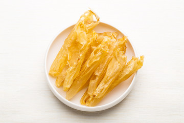 Dry fish gas bladder on white plate
