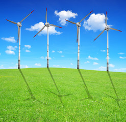 Fototapeta na wymiar Spring meadow with wind turbines