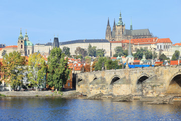 Fototapeta na wymiar Autumn Prague gothic Castle with Charles Bridge, Czech Republic