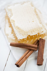 Vertical shot of honeycomb and cinnamon sticks, close-up