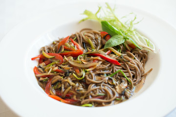 Close-up of buckwheat udon noodles with vegetable sauce
