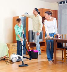 Parents and  boy cleaning together