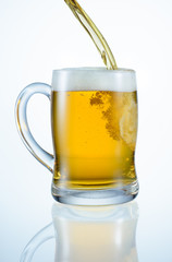Beer is pouring into mug