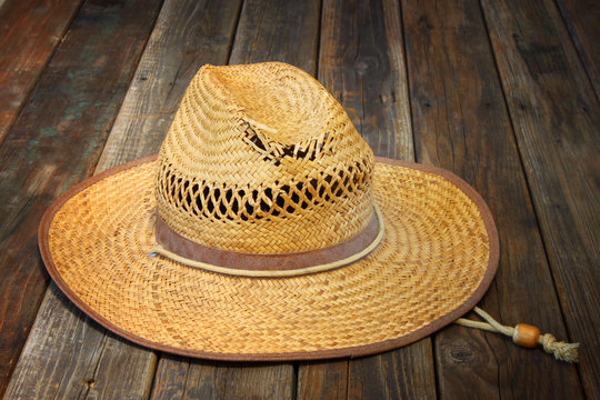 straw hat on wooden table