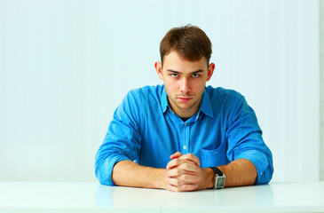 Portait of a young confident businessman sitting 
