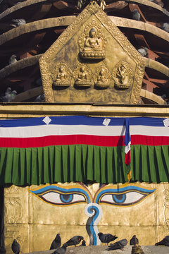 Buddha eyes and Pancha buddha sculpture in to of buddhist stuppa