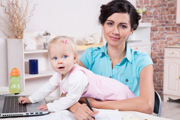 business woman with laptop and her baby girl