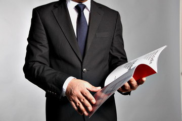 Bisnessman holds a booklet
