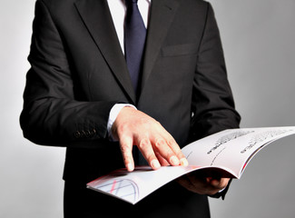 Bisnessman holds a booklet