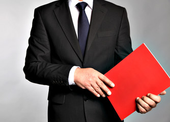Bisnessman holds a booklet