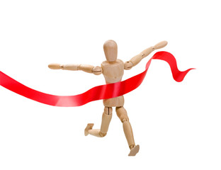 Wooden figure of a man running a leader winner on a white background with red ribbon. Business, sport. success concept