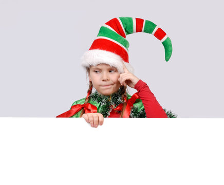Girl in suit of Christmas elf with the banner