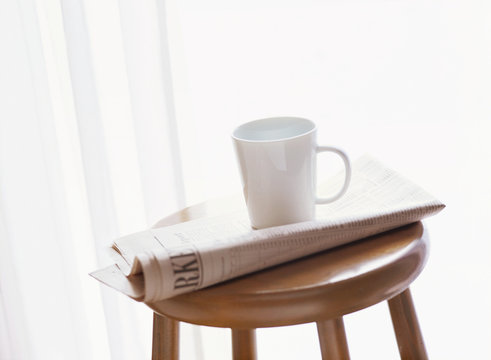 newspaper and coffee cup