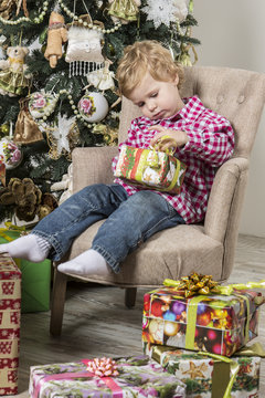 Young boy intrigued with Christmas gift